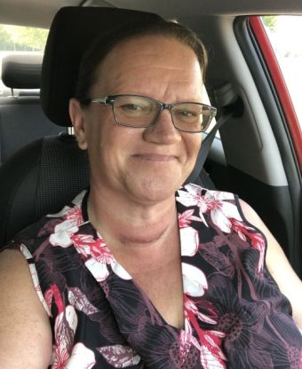 A woman looking at her smartphone while smiling.